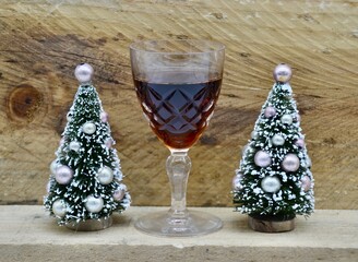 Two decoration Christmas trees on mantel with port wine