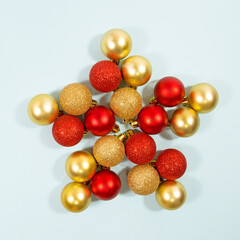 Close up of a star made of Christmas balls decoration. New year concept. Minimal layout. Flat lay. Christmas theme, greeting card, invitation.