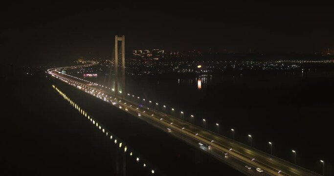 Ambulance and police are driving with siren on over the bridge at night aerial view