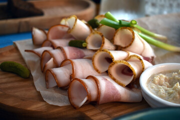 lard with a layer of meat on a wooden board