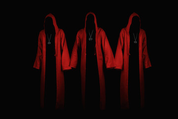 Group of mystery people in a red hooded cloaks.  Unrecognizable person. Hiding face in shadow. Ghostly figure. Satanic sect member. Conspiracy concept. Isolated on black. - obrazy, fototapety, plakaty
