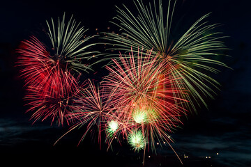 Fototapeta na wymiar Colorful fireworks on black background. Celebration and holidays concept. Independence Day 4th of July, New Year, festival. Bright explosions of lights in sky.
