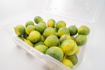 Fresh little limes on pure white background