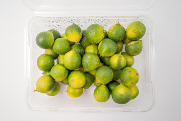 Fresh little limes on pure white background