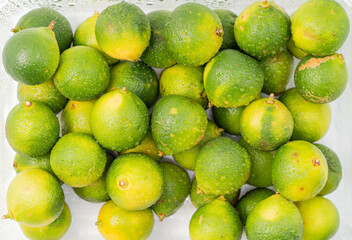 Fresh little limes on pure white background