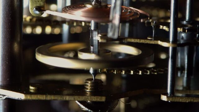 Macro video of the primitive clockwork mechanism of an old desktop alarm clock