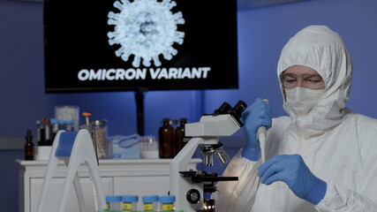 laboratory tech uses pipette to sample omicron variant