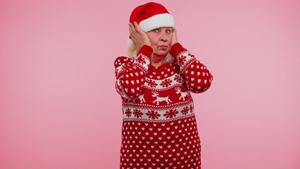 Dont want to hear and listen. Frustrated irritated senior grandmother woman in Christmas clothing...