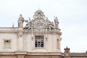 Fototapeta na wymiar St Peter's Basilica Exterior Close Up with Sculptures and Italic Time Clock in Rome, Italy