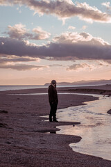 photo at the beach in front of an orange sunset