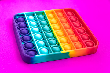 Naklejka premium Fidget pop it toy rainbow color, antistress, fun and educational