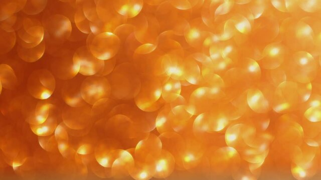 moving gold defocused blurred glitter lights background. abstract yellow holiday concept mood. bloating and decreasing motion increasing dots bokeh in seamless loop.