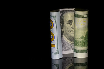 One Hundred Dollar Bill, US, on Black Background with Benjamin Franklin, Copy space on Left
