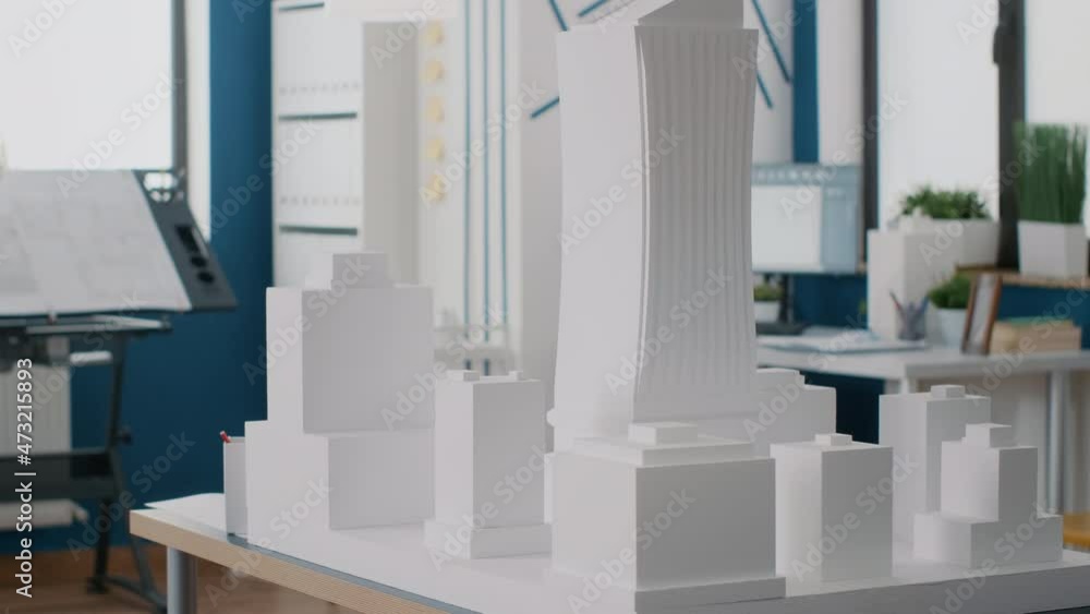 Poster close up of building model on table in empty architectural office. nobody in workplace used for arch