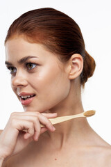 cheerful woman with bare shoulders toothbrushes hygiene oral care