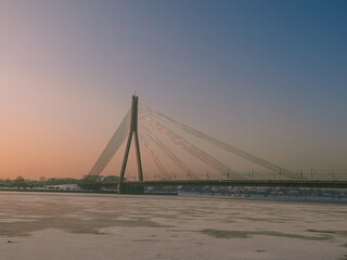 Cable-stayed bridge in winter in the city center, general plan