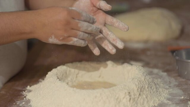 man's hands working with wheat flour