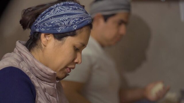 young adult preparing bread with her husband