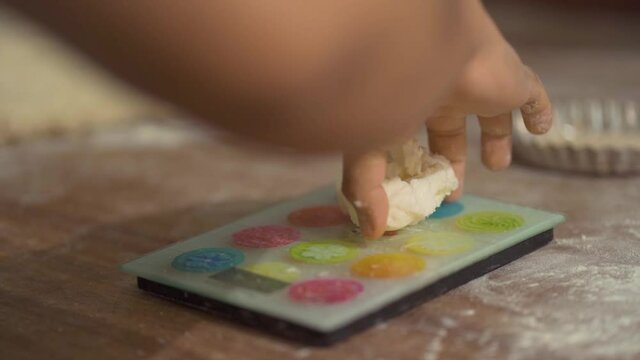 detail shot of hand weighing ball of bread
