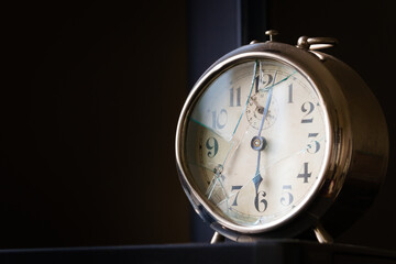 Old, broked mechanical alarm clock. Close up shot with negative space.