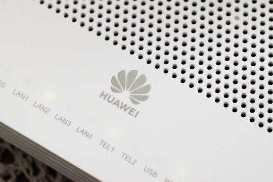 Huawei brand logo on the white plastic case of a modem router. Close up detail.