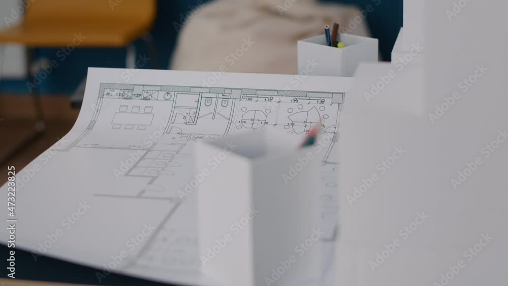 Poster close up of paper with blueprints plans on table in architectural office. industrial sketch with bui
