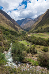 Fototapeta na wymiar River Flowing Through Green Valley in the Andes Mountains of Peru