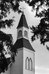 Fototapeta na wymiar Photo of a little white wooden church in the countryside. Church in rural British Columbia, Canada