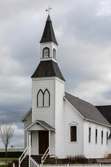 Fototapeta na wymiar Photo of a little white wooden church in the countryside. Church in rural British Columbia, Canada