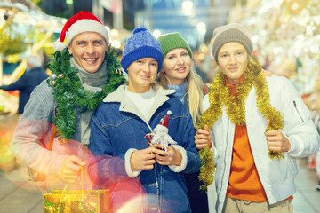 Fototapeta premium Happy parents and kids visiting christmas fair together.