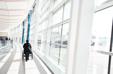 Fototapeta na wymiar Woman assisting person on wheelchair at airport