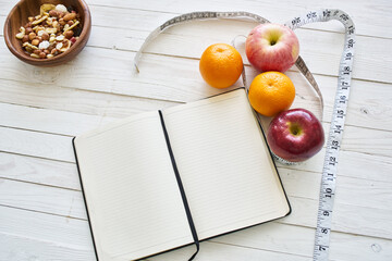 notepad on table measuring tape fruit breakfast nutritional fitness
