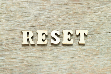 Alphabet letter in word reset on wood background