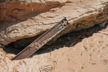 Hiking Trail sign in desert fell down in mud after big rain