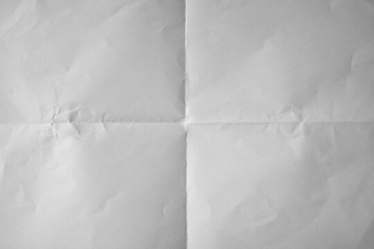 Uneven white paper folded in four fraction background
