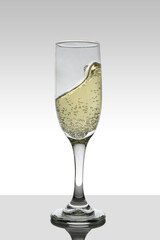 glass with moving white wine and white gradient color background with coffee.