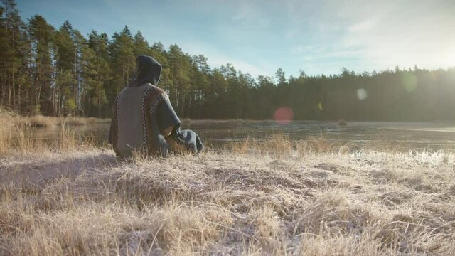 TRACKING shot R-L of an ice bather conscious breathing before going in a frozen lake