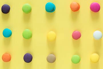 Sweet and colorful french macaroons or macaroon on yellow background, Dessert eating with tea or coffee