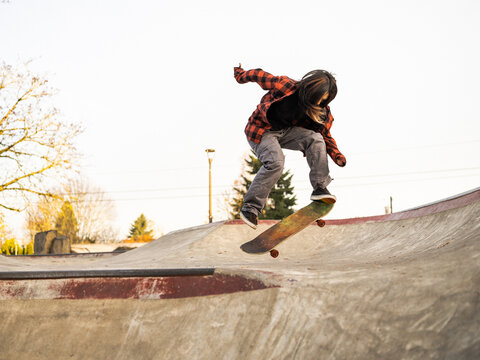 Young Indigenous non-binary skater outdoors