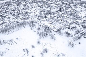 Fototapeta na wymiar suburb at wintertime. residential houses, covered with snow at winter season. aerial view.