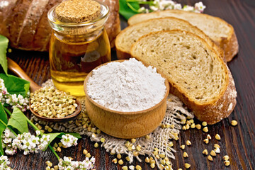 Flour buckwheat green in bowl with bread on dark board