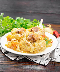 Pasta with meatballs in plate on napkin