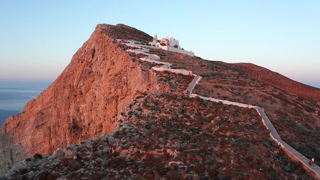 Aerial towards Scenic Panagia church on Hilltop, at beautiful Sunset lights, Folegandros Island