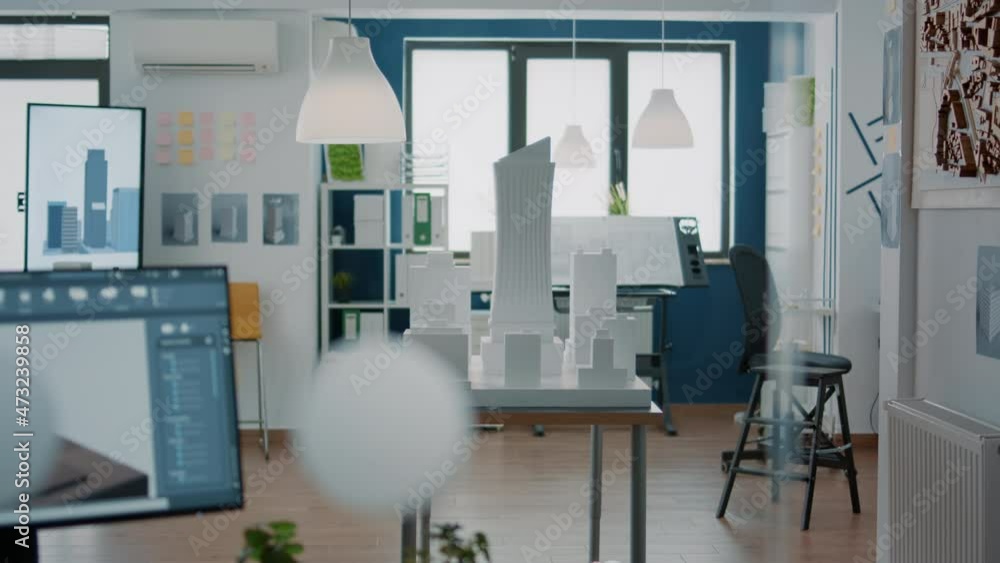 Poster empty architectural office with building model and blueprints plans on table. nobody in space used f