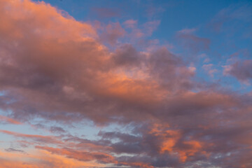 different colored clouds by sunset