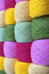 Close Up of yarn balls. Rainbow colors. Yarn for knitting. Skeins of yarn. Knitting needles, colorful threads. Knitting background, Knitting yarn for handmade winter clothes.