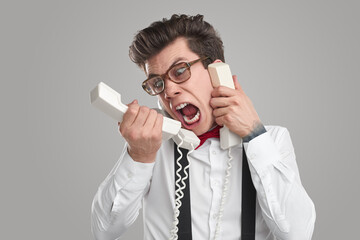 Funny stressed man talking on telephone
