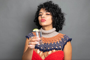 beautiful Mexican woman toasting with shot of silver tequila - obrazy, fototapety, plakaty