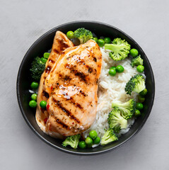 Grilled chicken with green vegetables and rice.