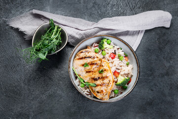 Grilled chicken with vegetables and rice.